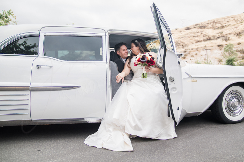 A couple looking at each other inside a car